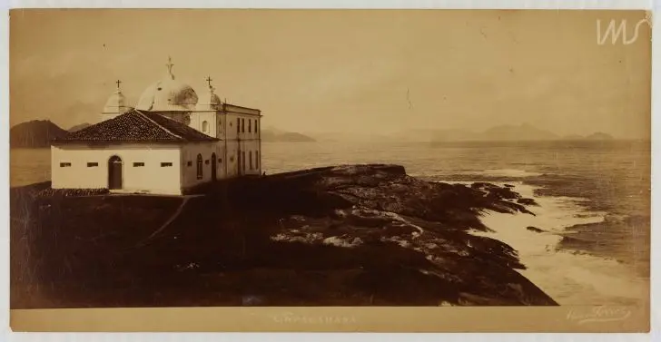Igreja rochosa à beira-mar, preto e branco.