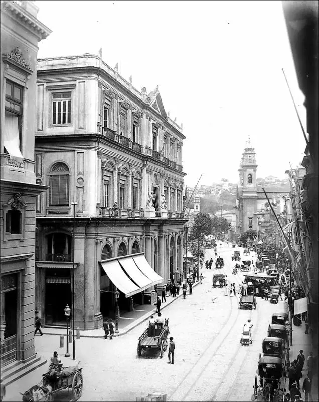 Uma rua animada do século XIX com construções históricas e carros de bois.