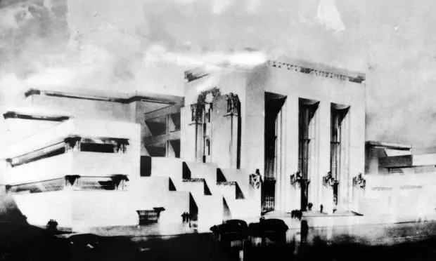 Edifício modernista com estrutura retangular à esquerda, construção elevada à direita e escadaria central.