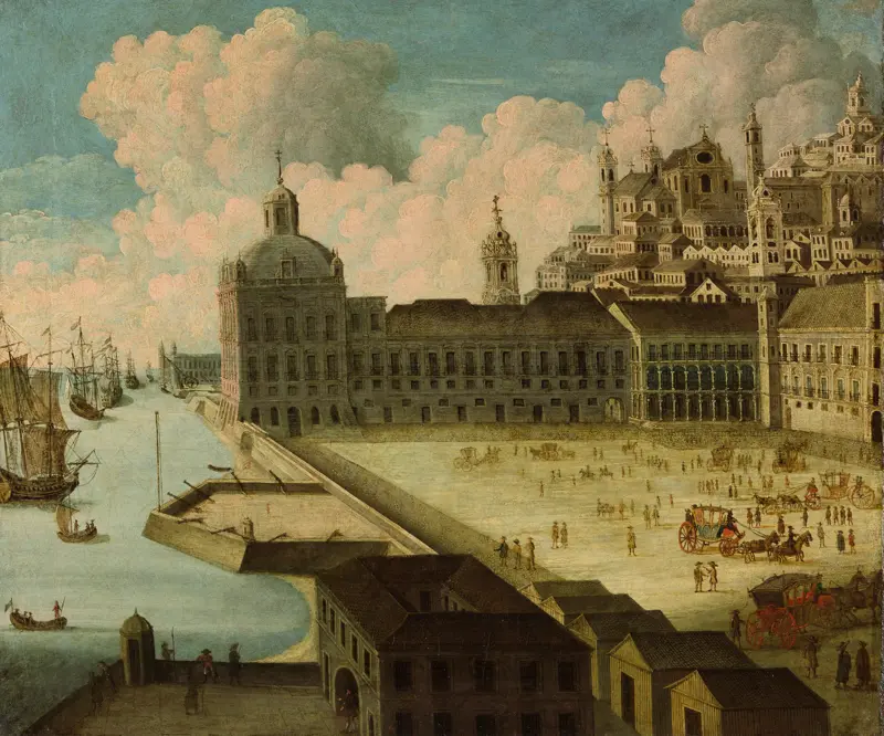Cidade histórica com rio, edifícios e pessoas caminhando.