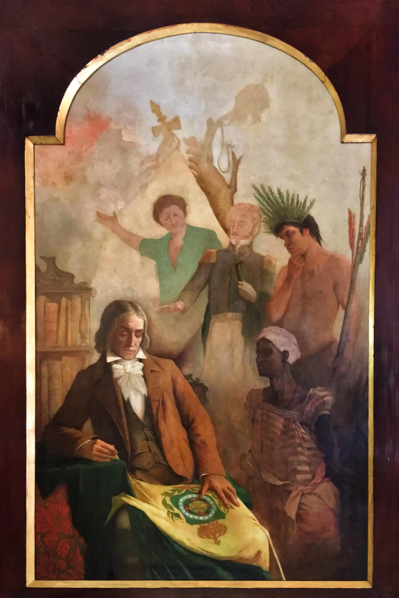 Pintura histórica com figura sentada segurando bandeira amarela, três figuras humanas e árvore com cruz.