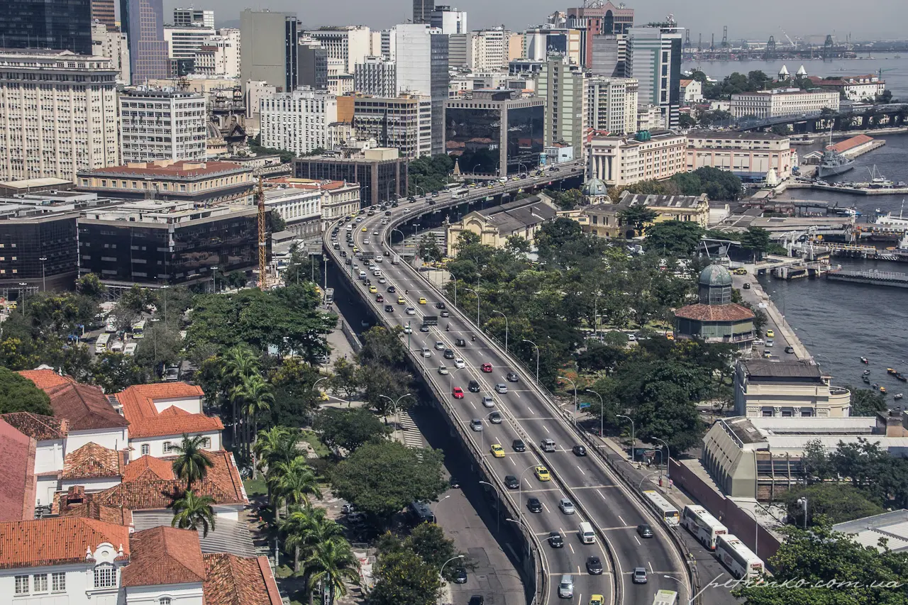 Cidade com via expressa, edifícios e rio.
