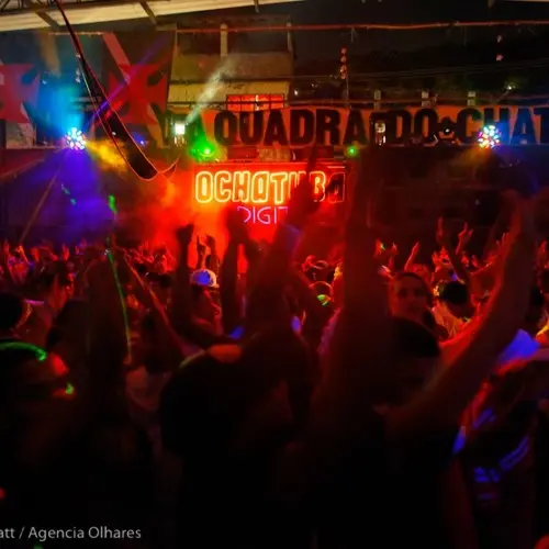 Baile animado com dança e luzes coloridas.