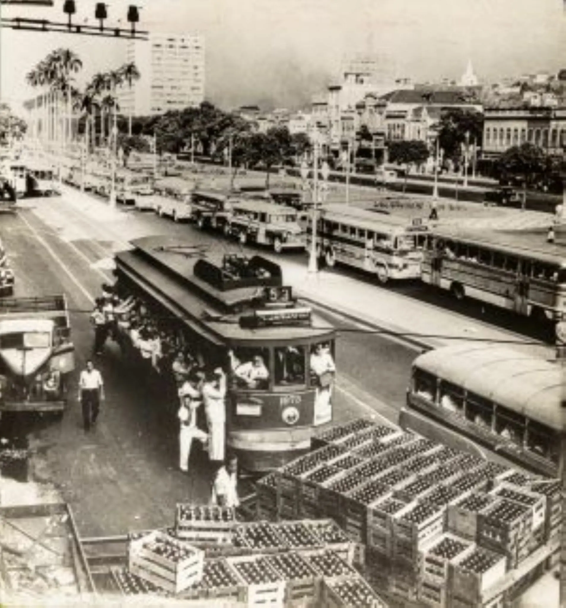 Cenário urbano com engarrafamento e trem em plataforma elevada.