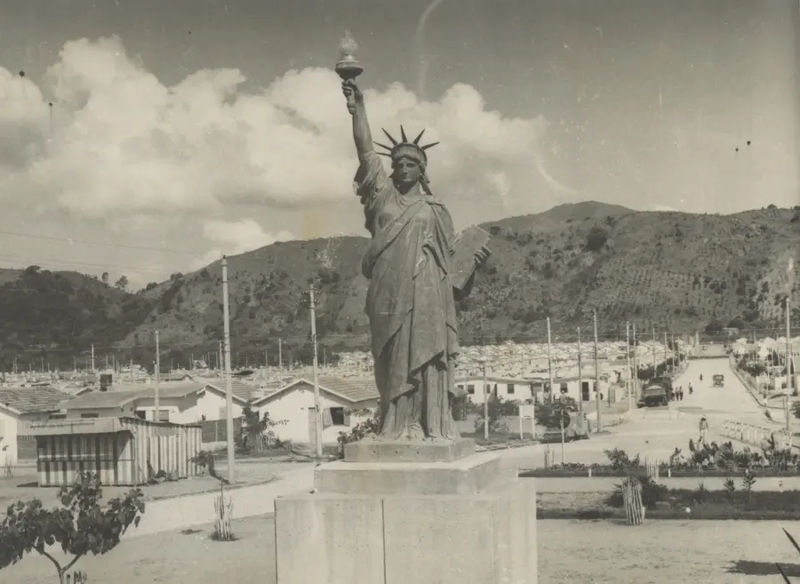 Estátua da Liberdade em preto e branco, com lanterna erguida.