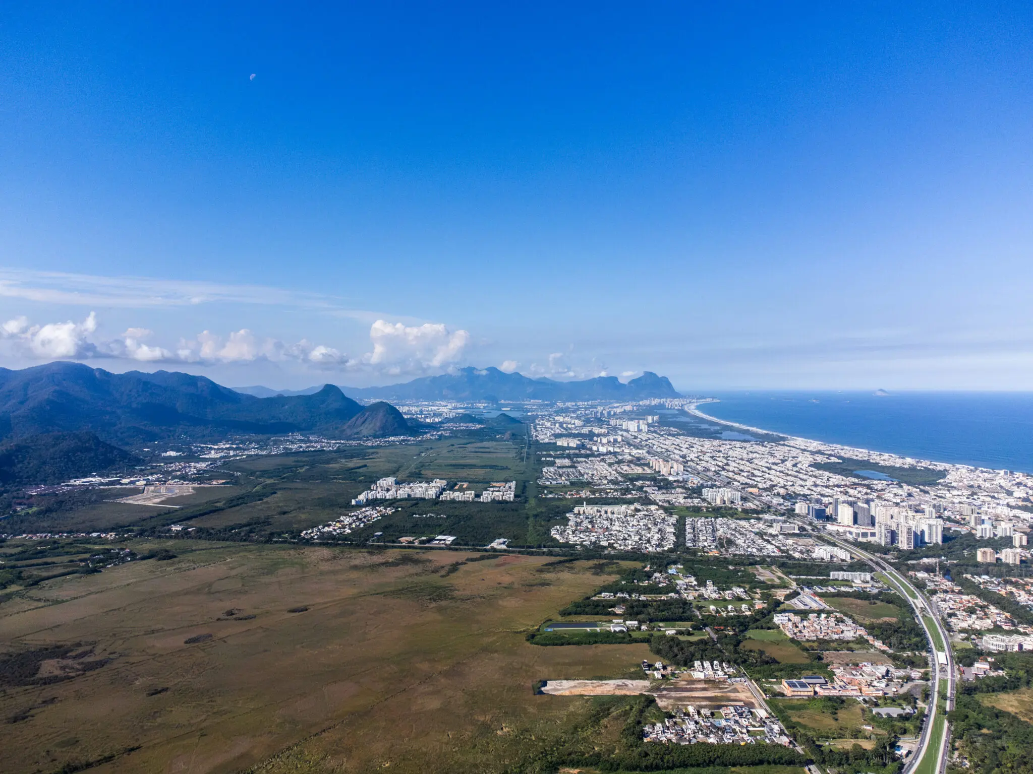 Área costeira com cidade e montanhas.
