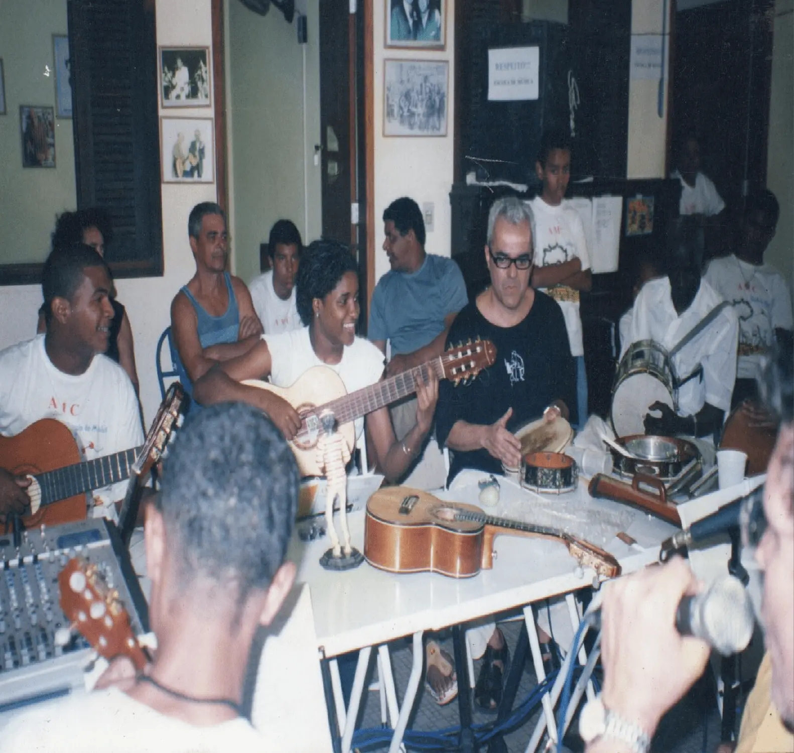 Grupo reunido em sala de prática musical, focando em atividades musicais.