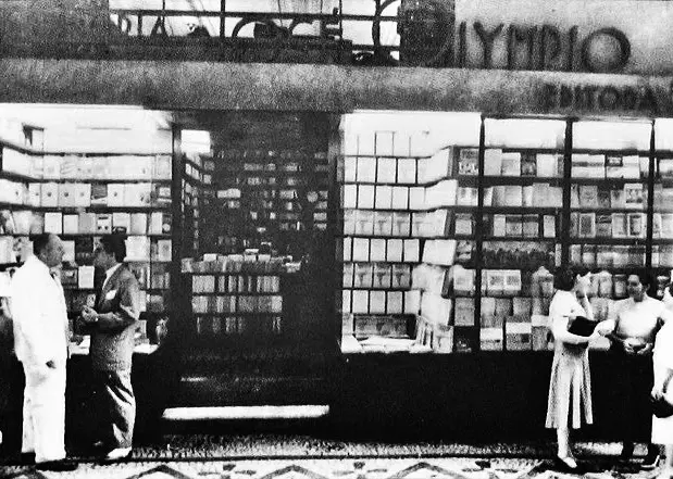Livraria preto e branco com pessoas segurando objetos e estante de livros.